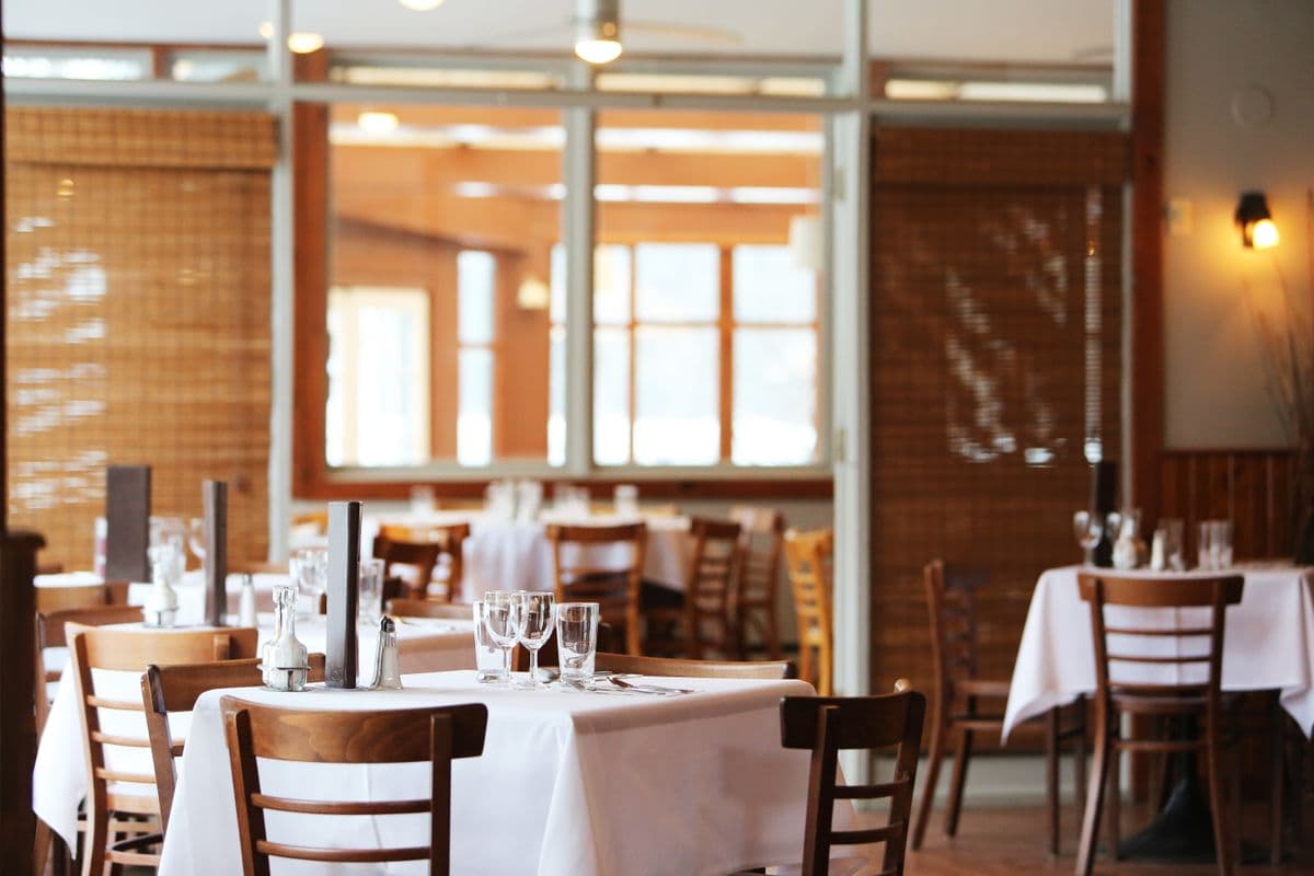 Steak and vegetables served in an elegant dark dining room