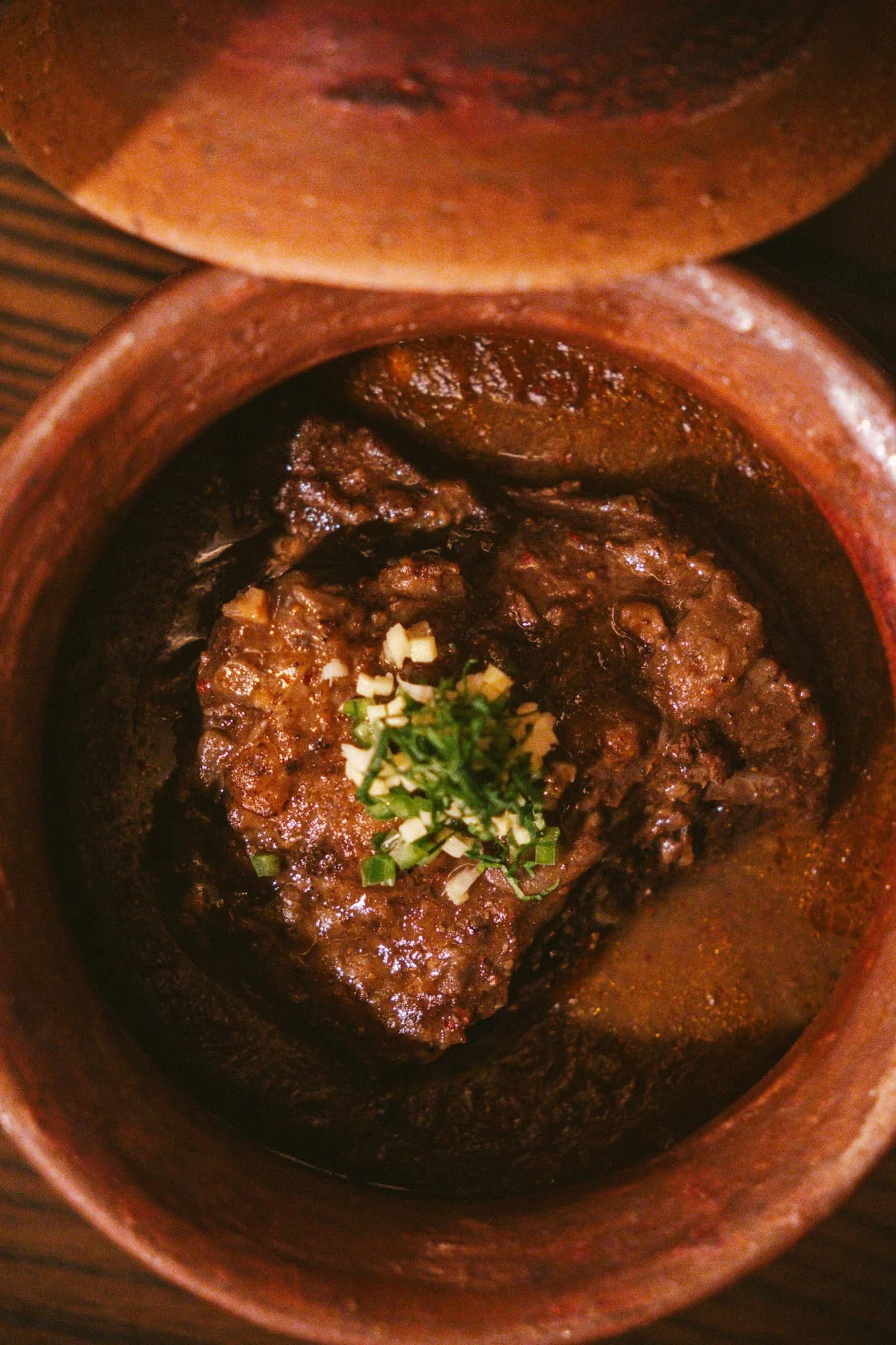 A richly plated goat biryani dish at Muhajir in Chicago