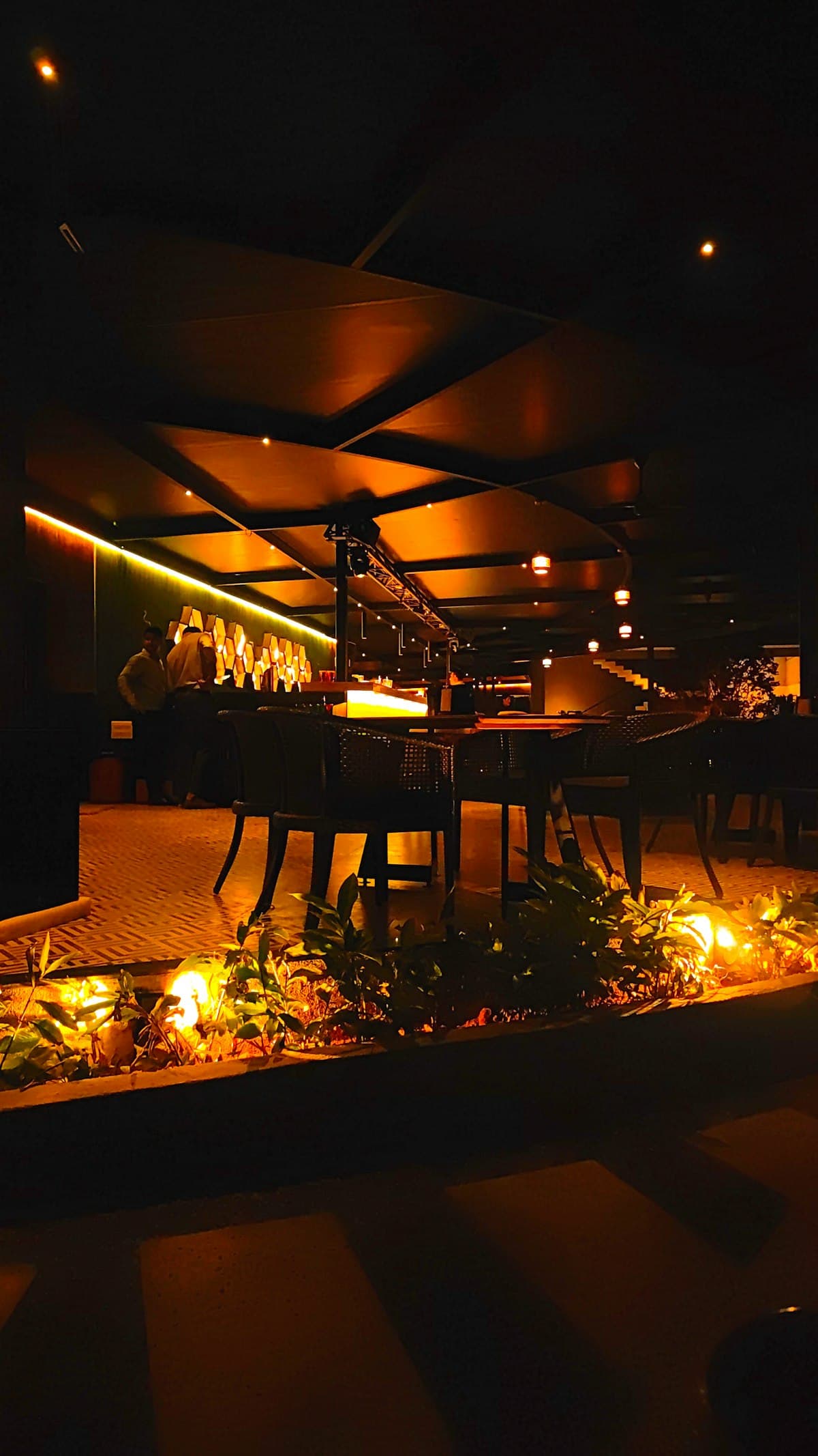 Warmly lit New York restaurant dining room set for dinner service