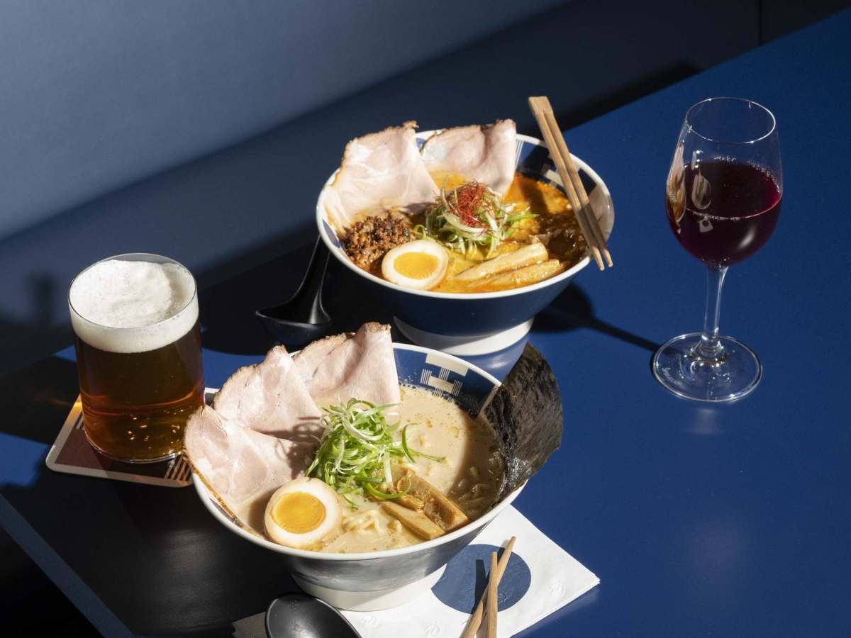 Stylish ramen counter and dining room with warm lighting in a modern basement restaurant