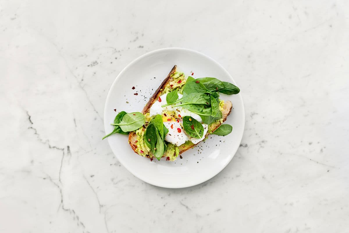 Fresh flatbread wraps with herbs and vegetables on a shared table