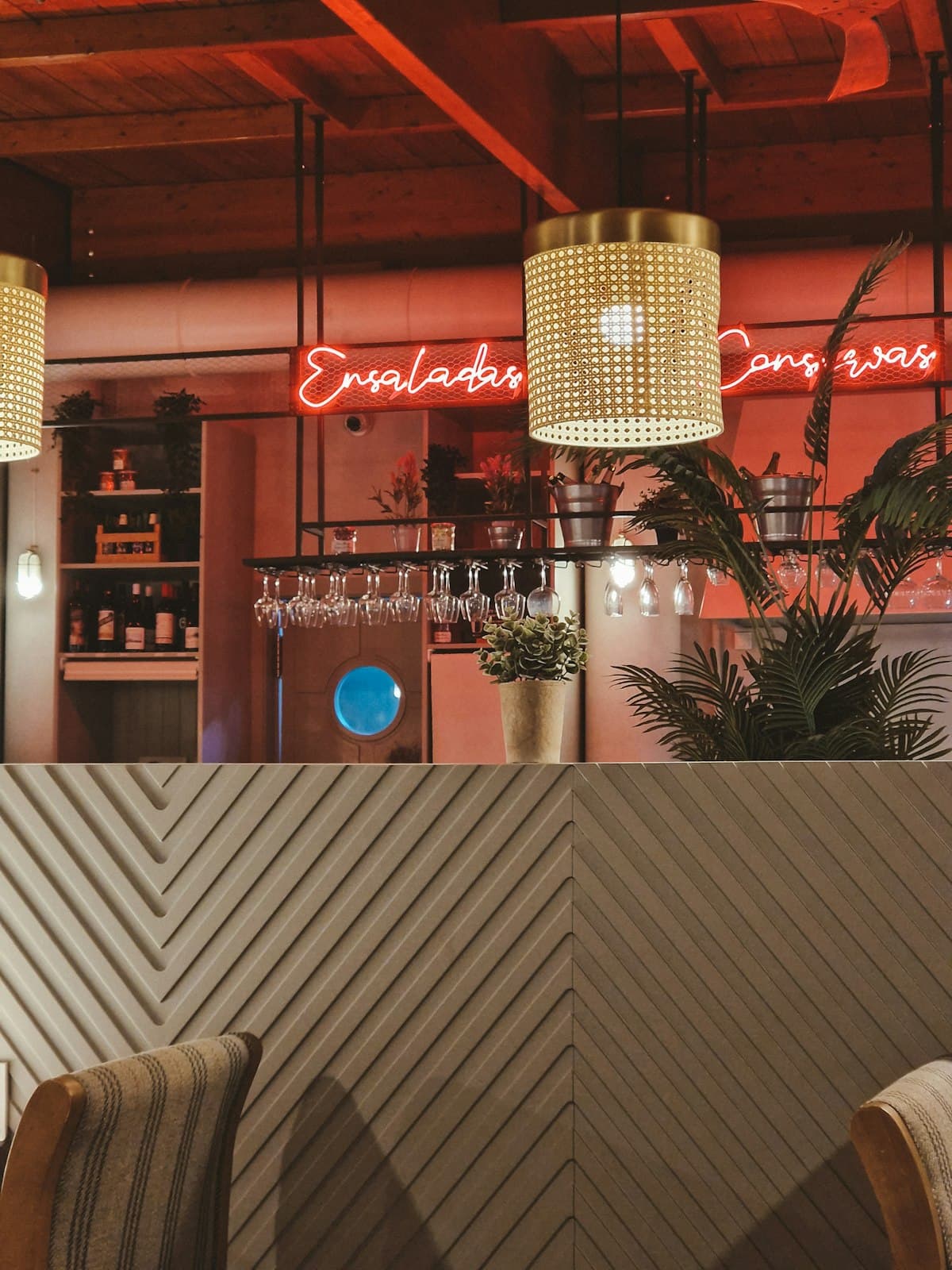 Stylish restaurant bar with warm lighting, stools, and a polished dinner-party atmosphere