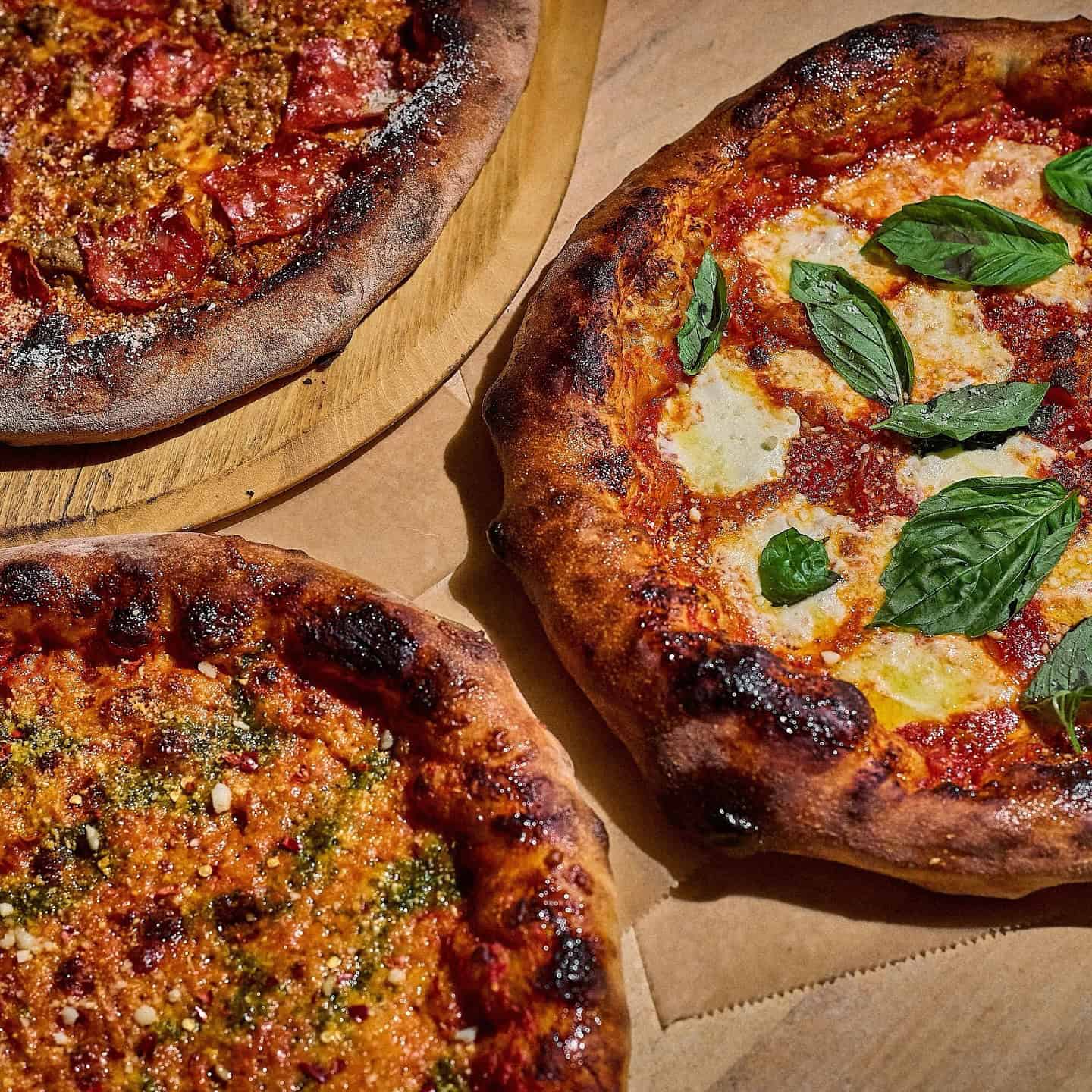 A Chicago restaurant table with pizza, cocktails, and warm evening light