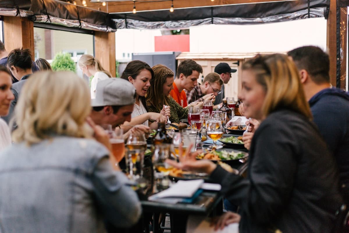 Friends sharing dishes at a warmly lit bistro table