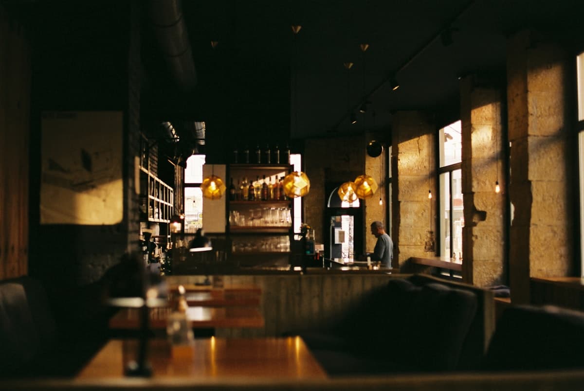 A warmly lit restaurant dining room set for evening service