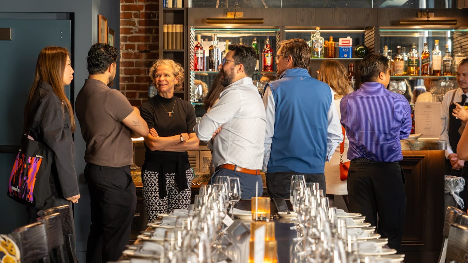 Guests gathered around a long table in a warm San Francisco dining room