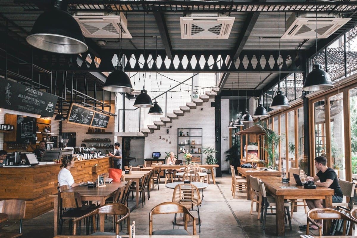 A stylish waterfront seafood restaurant with bright plates and evening light