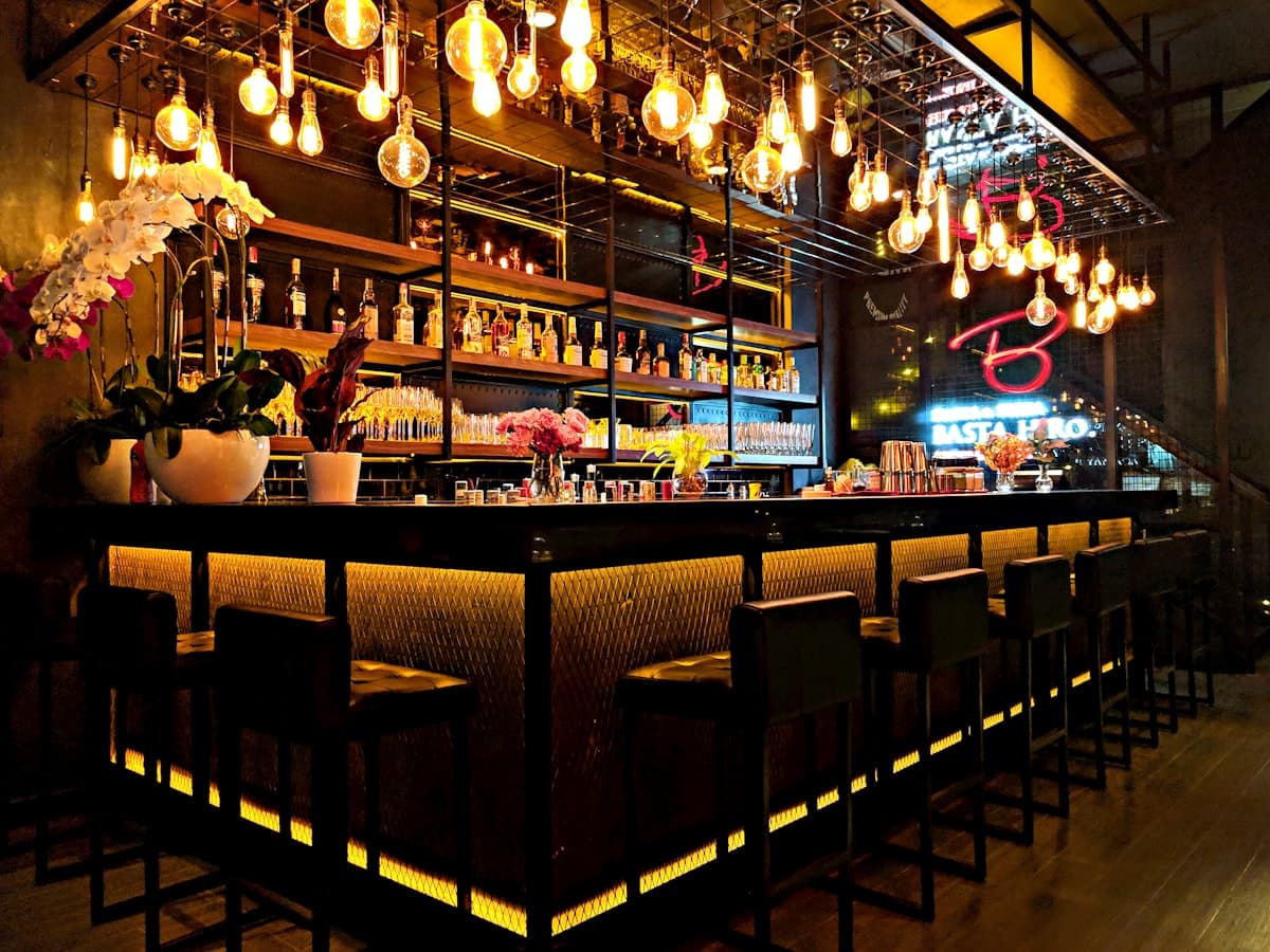 A lively rooftop bistro scene with cocktails, share plates, and warm evening light in Union Market