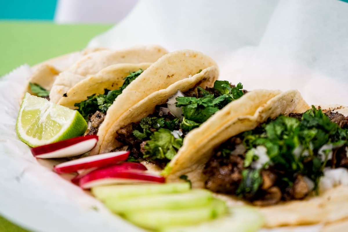 Warmly lit restaurant table set with colorful Mexican dishes