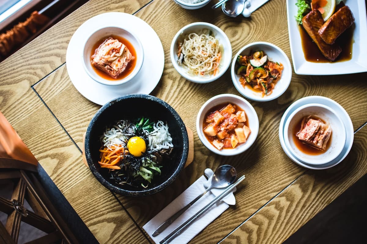 A lively restaurant table set for a meal with shared plates