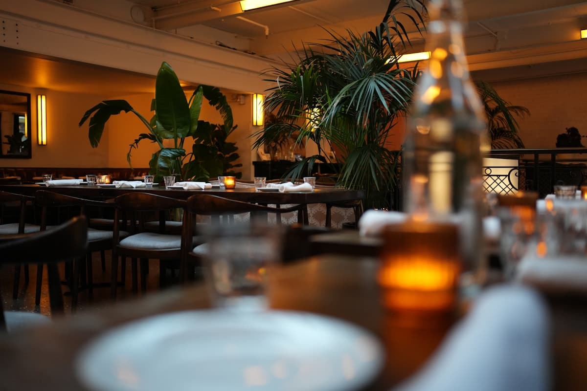 A softly lit New York restaurant dining room set for dinner service