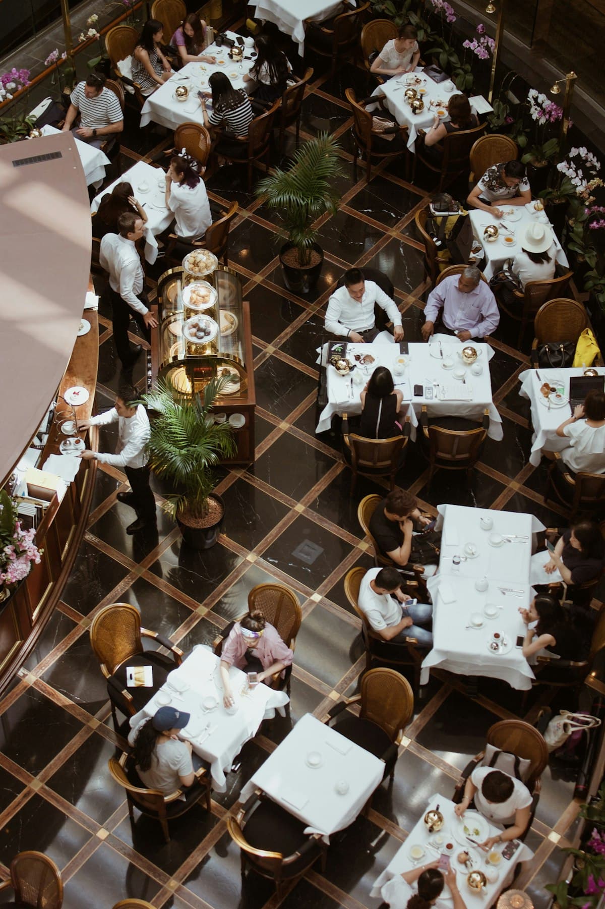 A stylish San Francisco restaurant dining room with cocktails, warm lighting, and full tables